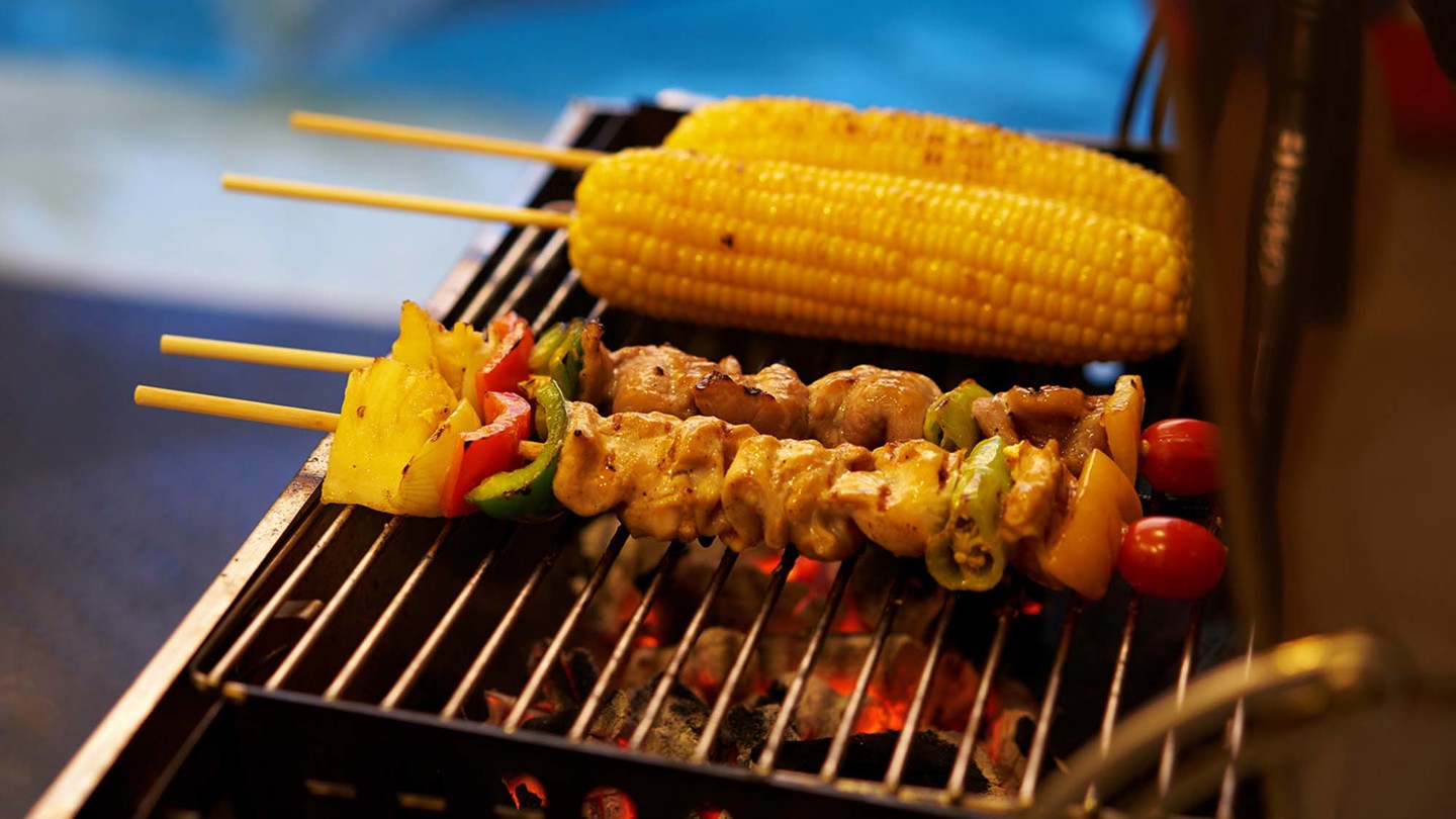 Kebabs and corn on a bbq