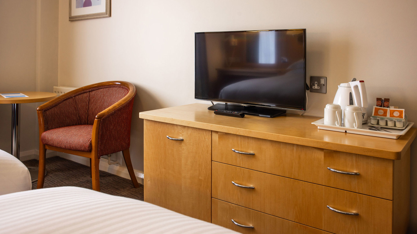 Wooden chest of drawers with TV and tea making tray