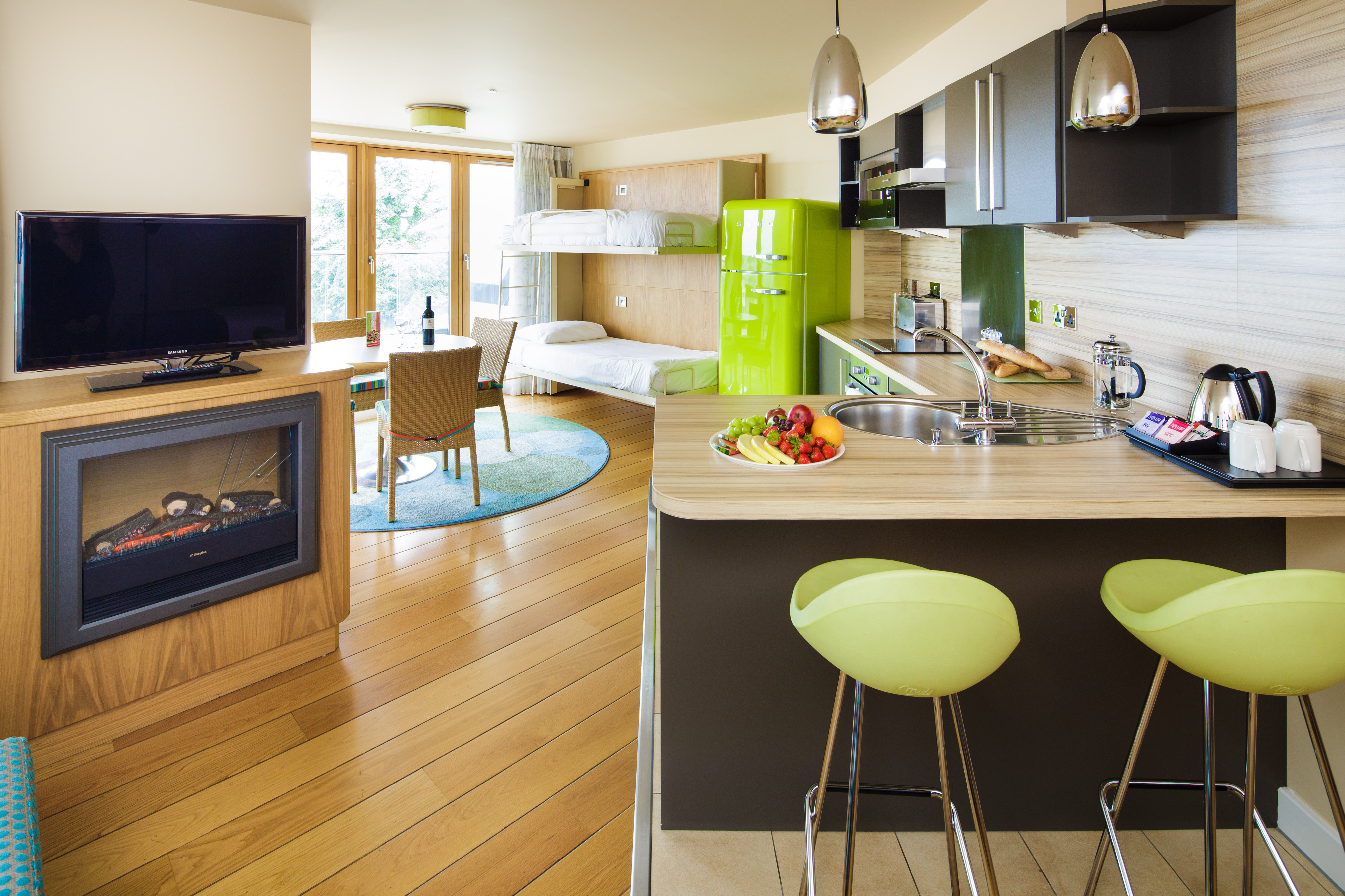 Merton Suites kitchen showing the bunk beds in the background.